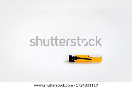a small glass bottle filled with aromatic oil is closed with a black lid. on white background