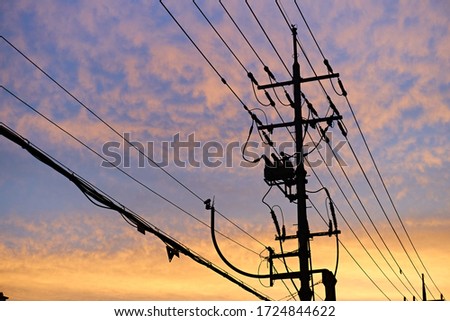 The beautiful silhouette of the telephone pole at sunset.                               