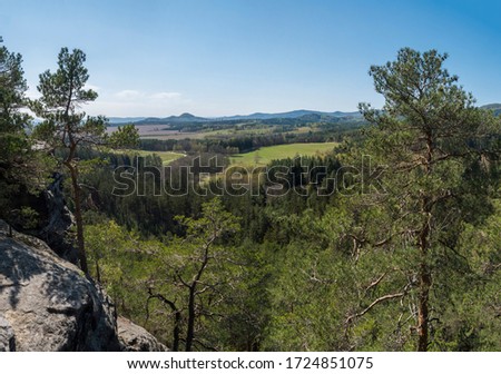 Panoramic view from sandstone rock viewpoint Havrani skaly, spring landscape in Lusatian Mountains , green hills, fresh deciduous and spruce tree forest. Blue sky background, copy space