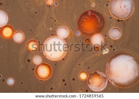Colorful circles on a brown background made of natural colors. Mixed watercolors and oils. Natural dynamic background.
