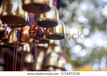 Close up of bell shaped decorative wind chimes with more in the background