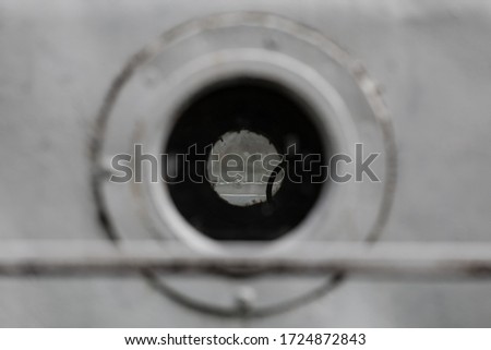 White porthole in the hold of an old ship