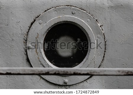White porthole in the hold of an old ship
