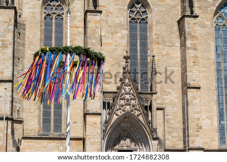 maypole in Osnabrück German city with cathedral architecture and blue sky