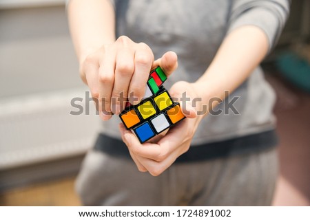 female hands holding a rubik's cube Royalty-Free Stock Photo #1724891002