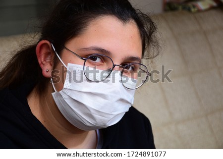 young beautiful girl wearing medical mask on face