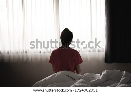Depressed asian woman has sad and lonely feel sitting on the bed in the morning. Royalty-Free Stock Photo #1724902951