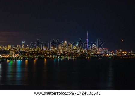 Skyline of Toronto over Ontario Lake at the night time.