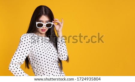 Asian woman in summer casual clothes.She smiling and  happy shopping. she  lovely attractive shine on  yellow background.Summer Surprise Sale  concept.
