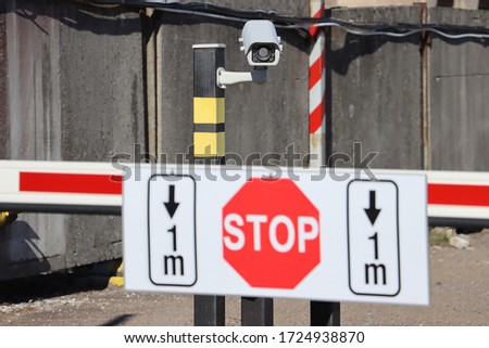 Security Video Camera Vehicle number identification system on the post. Stop sign on the barrier gate blurred. Selective focus