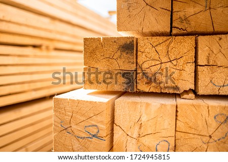 Stack of lumber wooden beams prepared to build a house Royalty-Free Stock Photo #1724945815