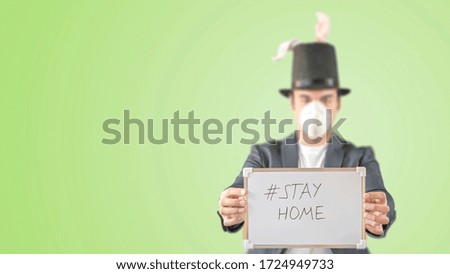 Easter holidays cancelled amid coronavirus covid-19 respiratory disease quarantine, lockdown in Europe. Conceptual photo of a man with rabbit ears and gift basket with toilet paper, sanitizer, mask.