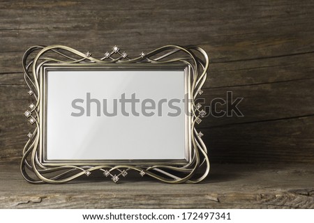 Empty wedding photo frame on wooden background