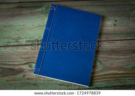 Handmade notebook on a wooden table. Hand sewn notebook