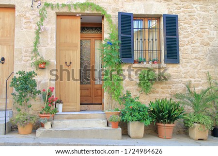 The picture was taken on the island of Palma de Mallorca, in the city of Alcudia. In the photo, the porch of the house, decorated with homemade flowers.