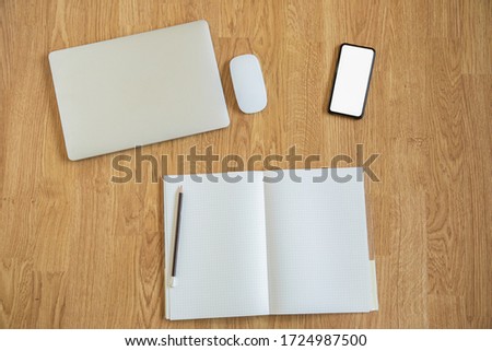 Top view shot of tools for working at home or anywhere in digital age which needs only smartphone, computer and laptop for connecting people around the world through wireless networking technology.