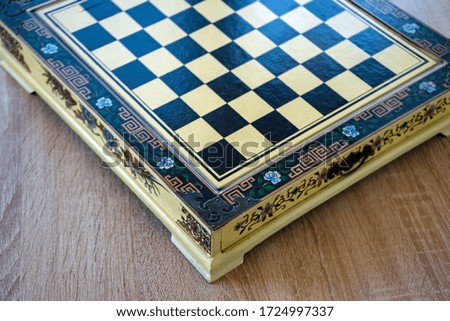 Close-up of a chess table. Beautiful box with floral decorations.
