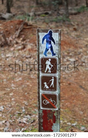 A galaxy Sasquatch sticker on a trail sign in Red Top Mountain State Park in northern Georgia.