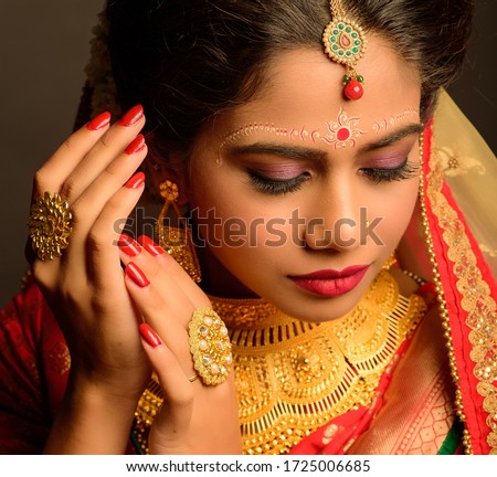 Beautiful Bengali Bride Wedding Day Portrait. A bride on her wedding day in traditional outfit and jewelry. Royalty-Free Stock Photo #1725006685