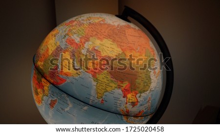 Earth globe on desk in office.world globe on a dark background.