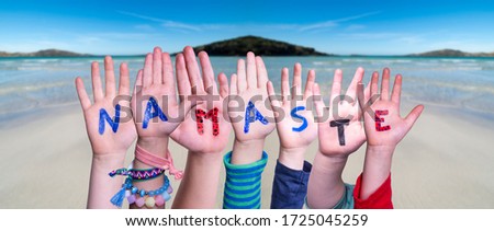 Children Hands Building Word Namaste Means Hello, Ocean Background