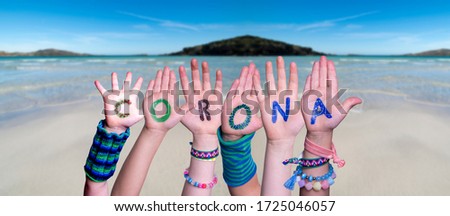 Children Hands Building Word Corona, Ocean Background