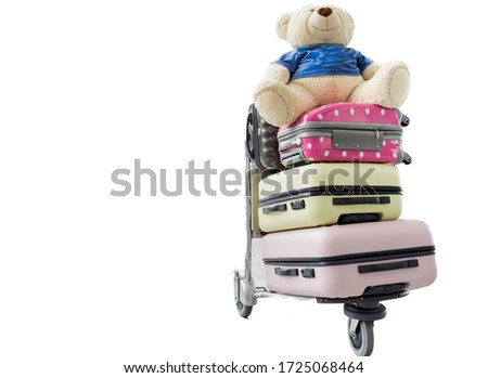 Cutouts of baggage cart with passenger suit case and teddy bear