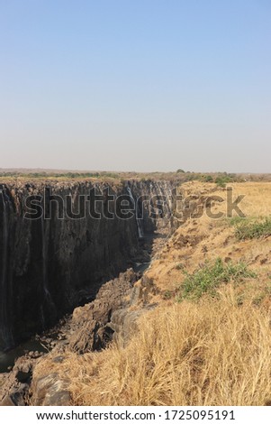 Victoria falls during dry season on holiday with sambesi river in zambia in africa.