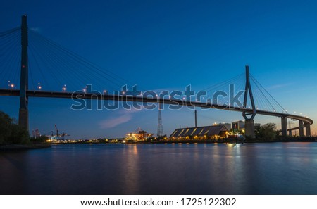 Steel cable suspension bridge in the harbor of Hamburg. Royalty-Free Stock Photo #1725122302