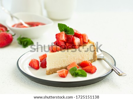 Slice of cheesecake with strawberries, mint and sauce. Selective focus Royalty-Free Stock Photo #1725151138
