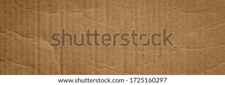 rectangular piece of corrugated brown cardboard, long web banner