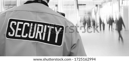 Security Representative Watches Supermarket Visitors