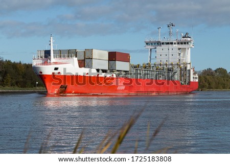 Nord-Ostsee-Kanal with red container ship near Rendsburg, Germany