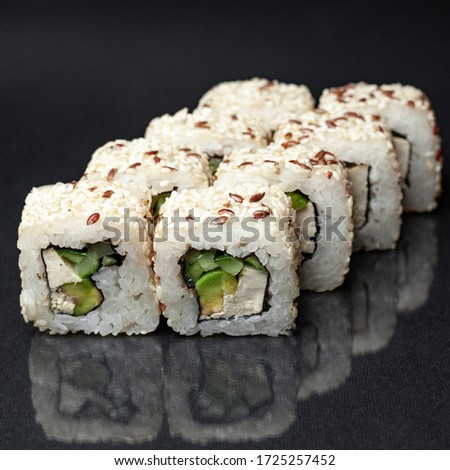 diverse delicious sushi roll set on a black background with reflection. menu