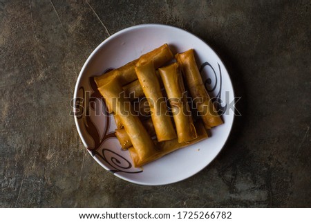 Malaysian famous fried spring roll 'popia' on the plate. pictures may have some noise
