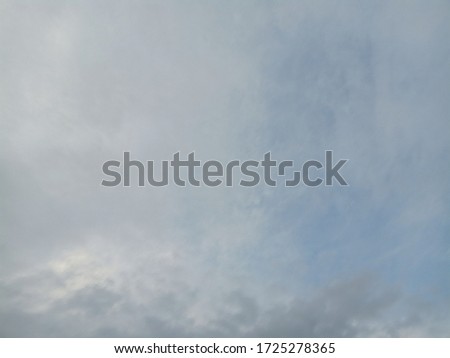 The sky background has bright white clouds with patterns.
