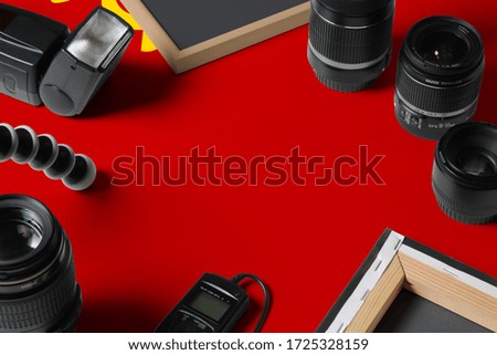 Soviet Union national flag with top view of personal photographer equipment and tools on white wooden table, copy space.