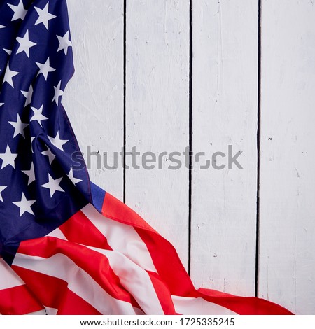 American Flag for the America's 4th of July Celebration over a white wooden rustic background to mark America's Independence Day. Image shot from top view.