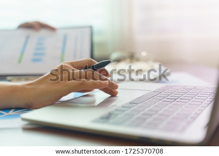 Closeup woman's hands typing on a laptop on a wooden desk.Working at home with laptop. Royalty-Free Stock Photo #1725370708