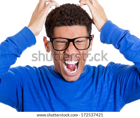Closeup portrait of frustrated, mad angry nerdy young man with big glasses, screaming hands raised, isolated on white background.  Negative emotions facial expressions feelings, body language