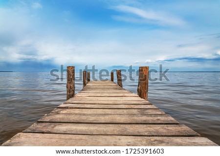 Perspective view of wooden pier at lake. Small bridge in water Royalty-Free Stock Photo #1725391603