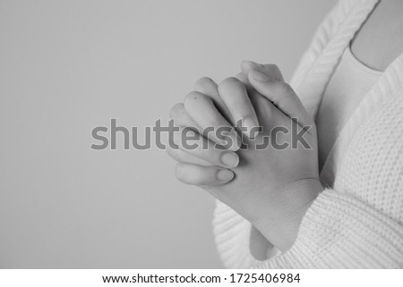 Black and white picture Woman hand praying to wishing have a better life. hand on table with copy space.
