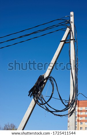 high-voltage line with wound wires against the sky. Power line post with a wound wire. The new wire is on the pole.