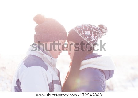 Young couple looking at each other in winter