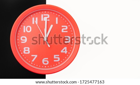 Clock on a black and white background with copy space: concept of a turning point.