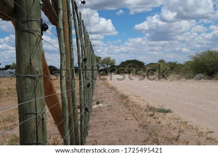 Wild animals fence with electric fence under african sky
