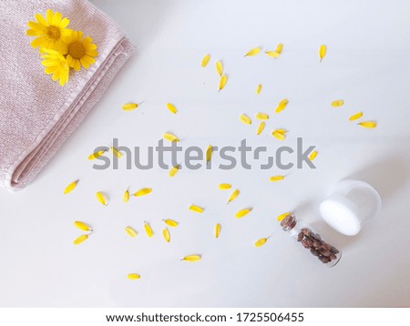 Facial body skin care cream, fresh calendula, chamomile flowers. Herbal cosmetic products. White background, top view.