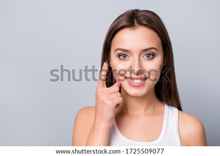 Portrait of positive cheerful girl care eye hold transparent contact lens her oculist prescribe remedy wear white tank-top isolated over gray color background Royalty-Free Stock Photo #1725509077