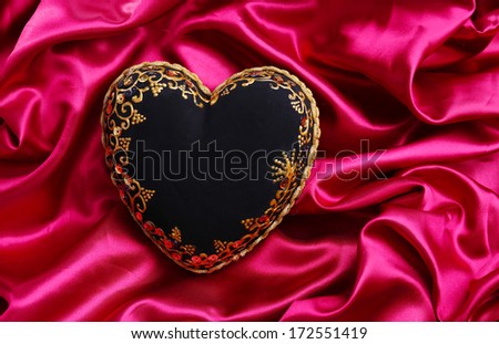 Decorative black heart, on color fabric