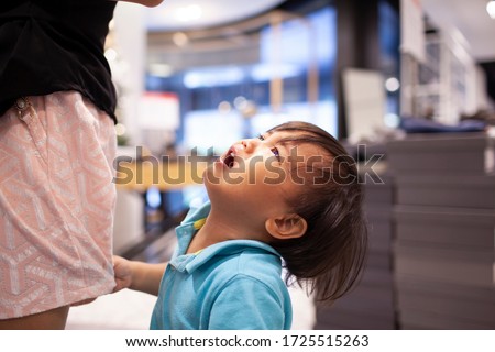 little boy crying to his mom asking for something Royalty-Free Stock Photo #1725515263
